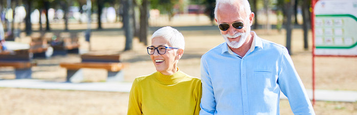 Older couple walking in the park.